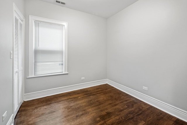 spare room with hardwood / wood-style flooring