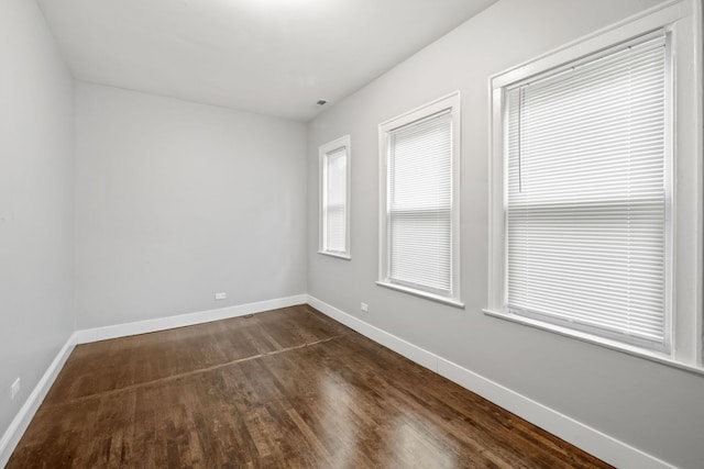 spare room with dark hardwood / wood-style flooring