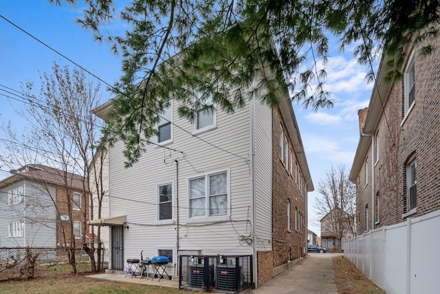 back of house featuring central AC unit