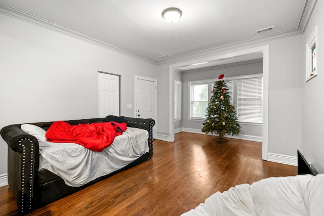 bedroom with hardwood / wood-style floors and ornamental molding