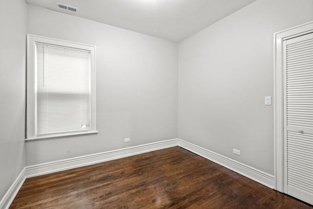 unfurnished room with dark hardwood / wood-style floors