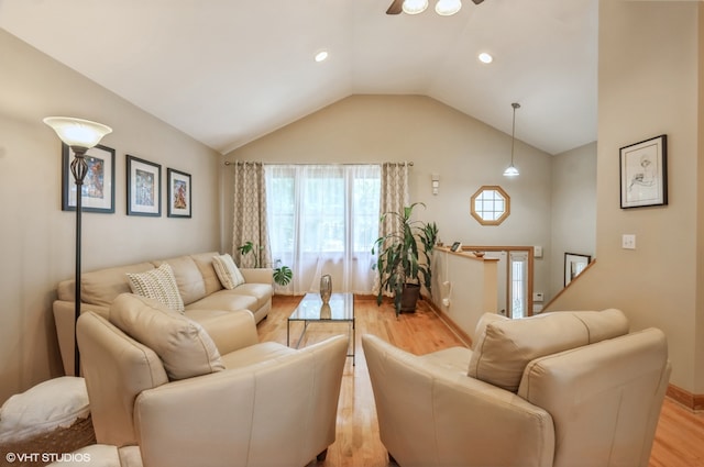 living room with light wood-type flooring and lofted ceiling