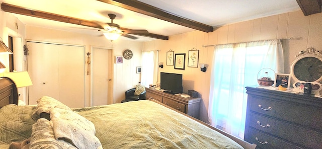 bedroom with beamed ceiling and ceiling fan