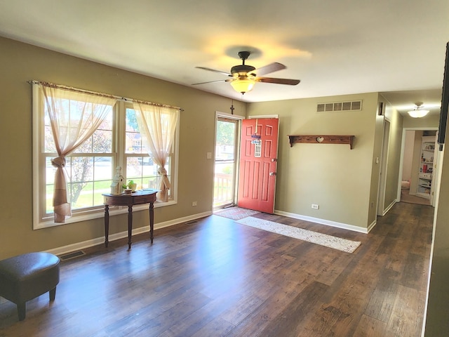 foyer with ceiling fan, dark wood-type flooring, and a healthy amount of sunlight