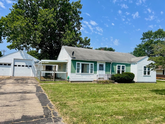 single story home with a porch, a garage, an outbuilding, and a front yard