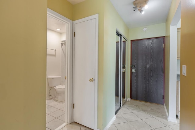 hall featuring light tile patterned flooring