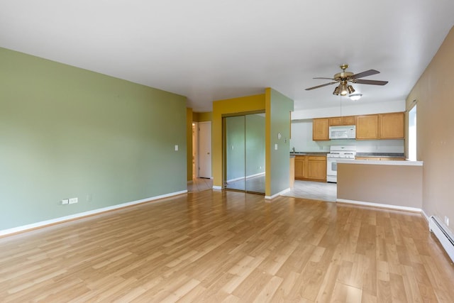 unfurnished living room with a baseboard heating unit, ceiling fan, and light wood-type flooring