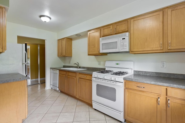 kitchen with sink, white appliances, and light tile patterned floors