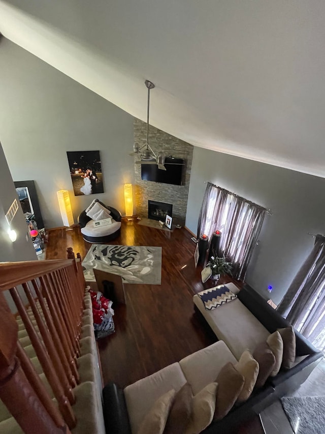 living room with hardwood / wood-style flooring, a fireplace, and high vaulted ceiling