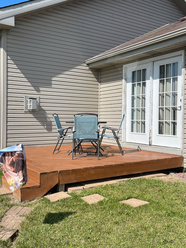 deck featuring a lawn and french doors