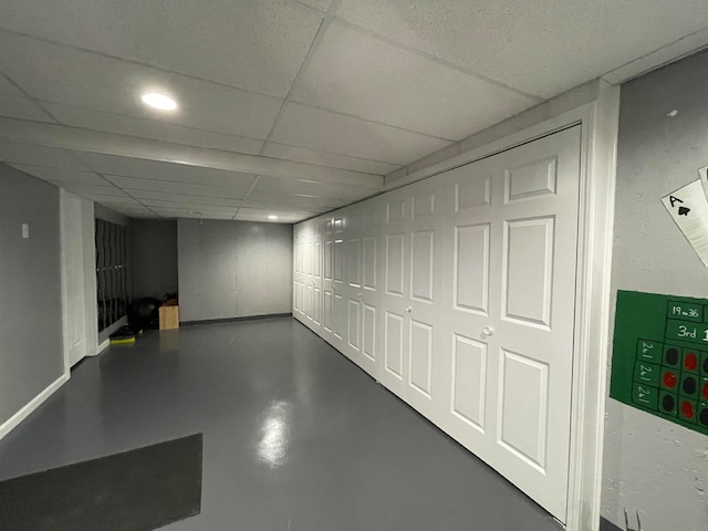 basement with a paneled ceiling