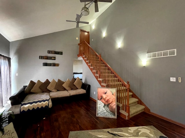 living room with dark wood-type flooring, ceiling fan, and high vaulted ceiling