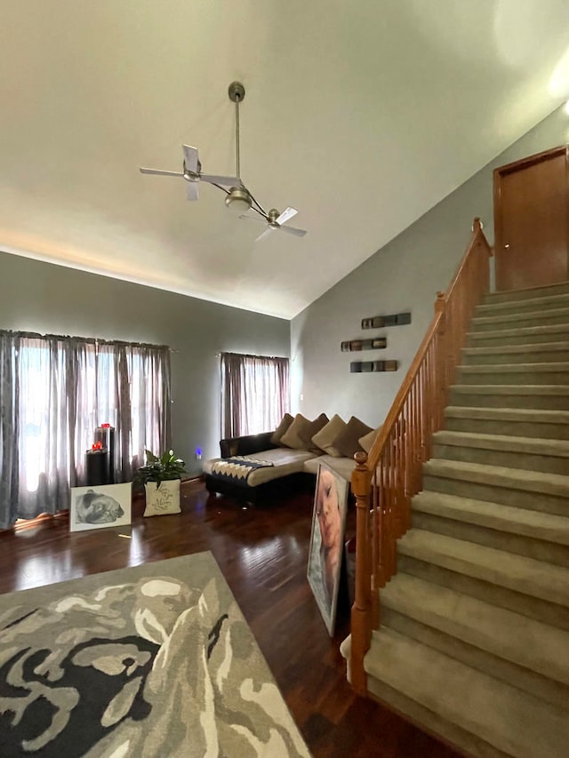 living room featuring wood-type flooring and high vaulted ceiling