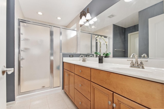 full bathroom featuring a shower stall, visible vents, a sink, and tile patterned floors