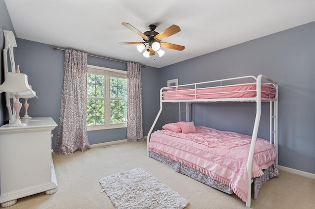 bedroom with a ceiling fan, baseboards, visible vents, and carpet flooring