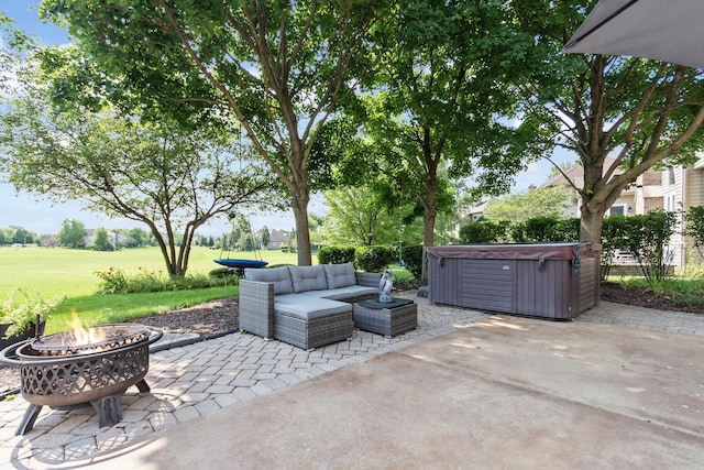 view of patio / terrace with a hot tub and an outdoor living space with a fire pit