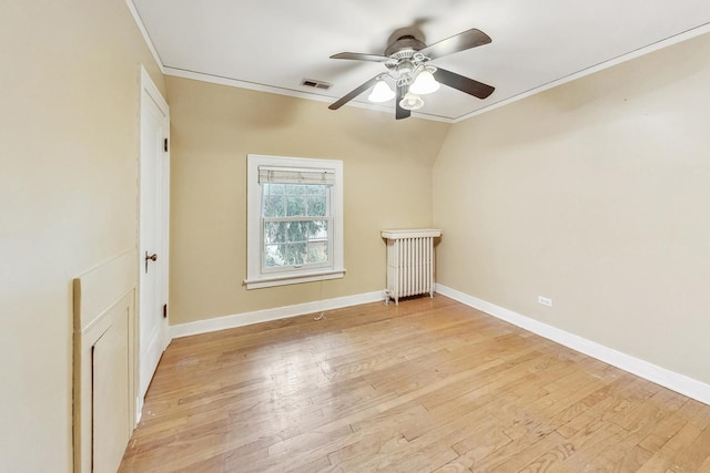 spare room featuring ceiling fan, light hardwood / wood-style floors, lofted ceiling, and crown molding