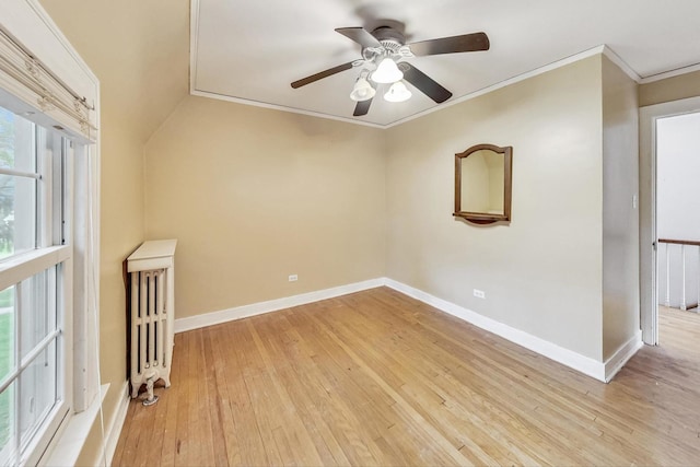 empty room featuring ceiling fan, light hardwood / wood-style floors, and crown molding