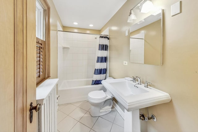 bathroom featuring shower / bath combo with shower curtain, tile patterned flooring, and toilet