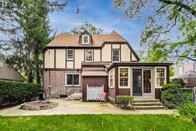 rear view of house with an outdoor fire pit