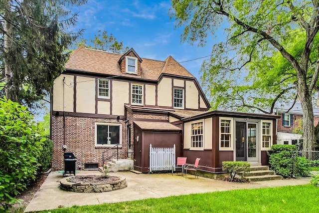 back of property with an outdoor fire pit