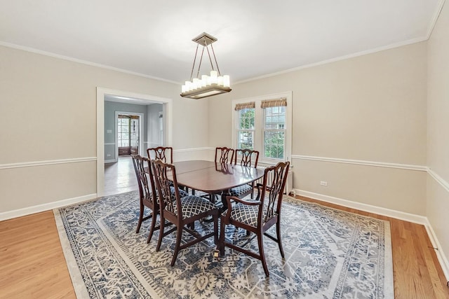 dining room featuring crown molding and hardwood / wood-style flooring