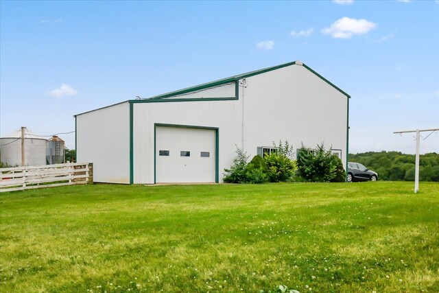 view of outbuilding featuring a garage and a lawn