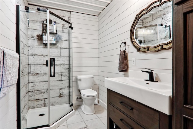 bathroom with tile patterned flooring, wooden walls, vanity, an enclosed shower, and toilet