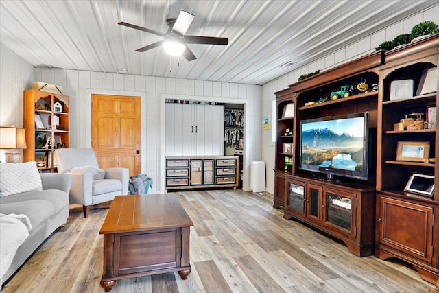 living room with ceiling fan and light hardwood / wood-style floors