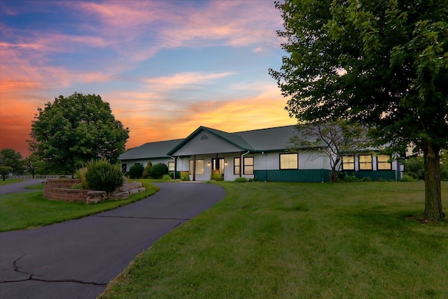 ranch-style home featuring a yard