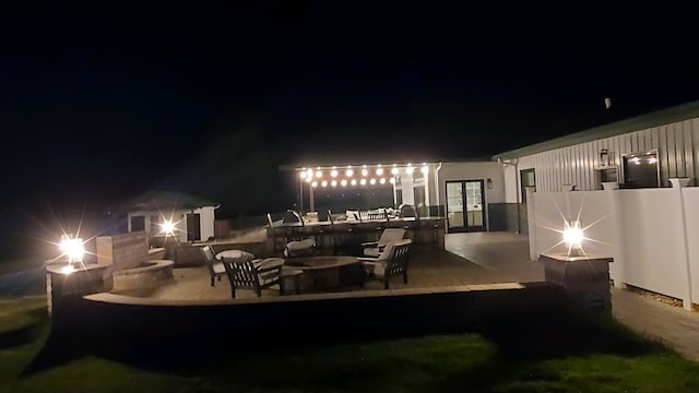 patio at twilight with french doors and a fire pit