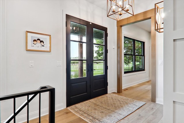 foyer featuring light hardwood / wood-style floors and french doors