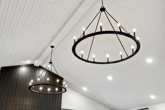 room details featuring beam ceiling and a chandelier