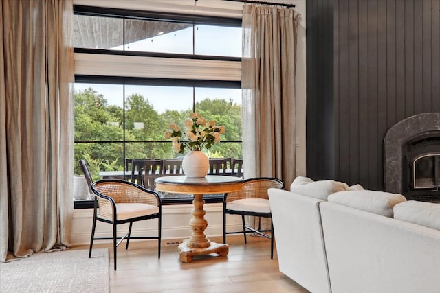 dining area with wooden walls and light hardwood / wood-style flooring