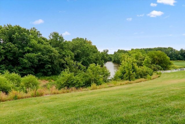 view of yard with a water view and a rural view