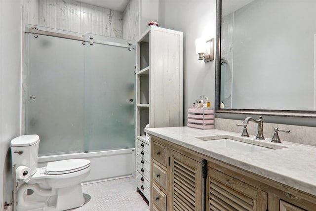 full bathroom featuring vanity, shower / bath combination with glass door, and toilet