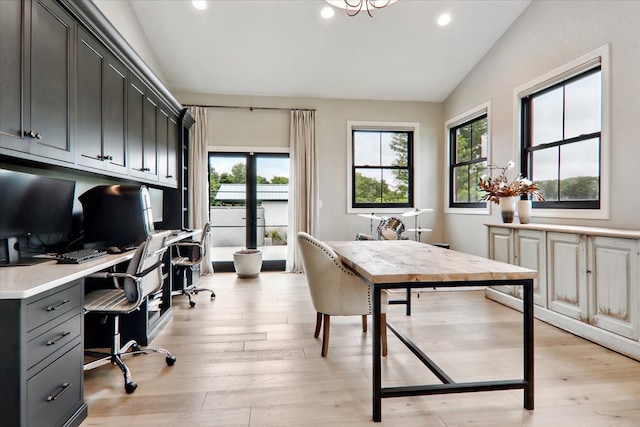 office featuring vaulted ceiling and light wood-type flooring