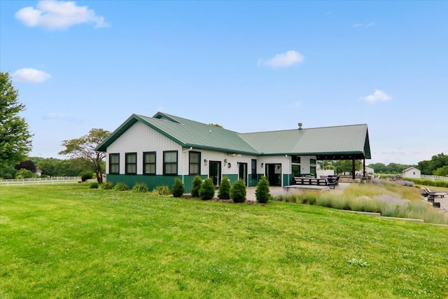 rear view of property featuring a yard