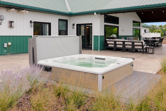 view of patio with an outdoor living space and a hot tub