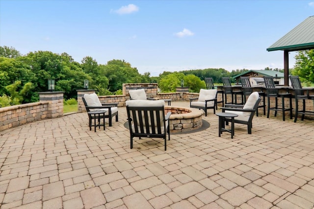 view of patio featuring an outdoor bar and a fire pit