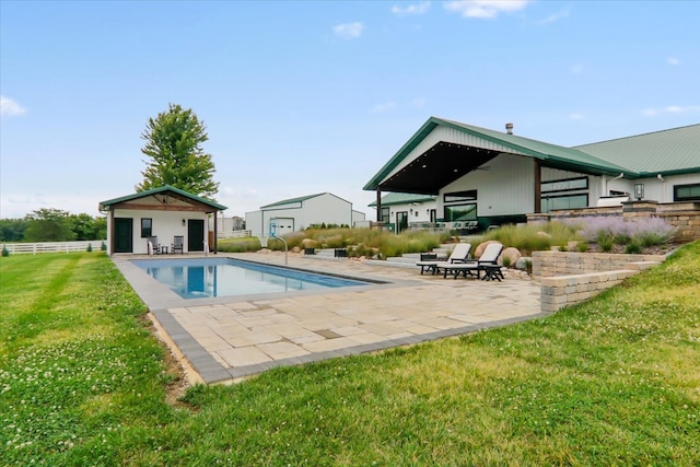 view of swimming pool with a patio and a lawn