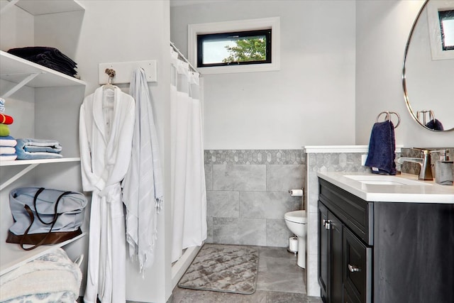 bathroom featuring tile walls, vanity, a shower with curtain, and toilet