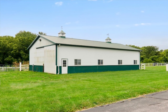 view of side of home featuring a yard and an outdoor structure