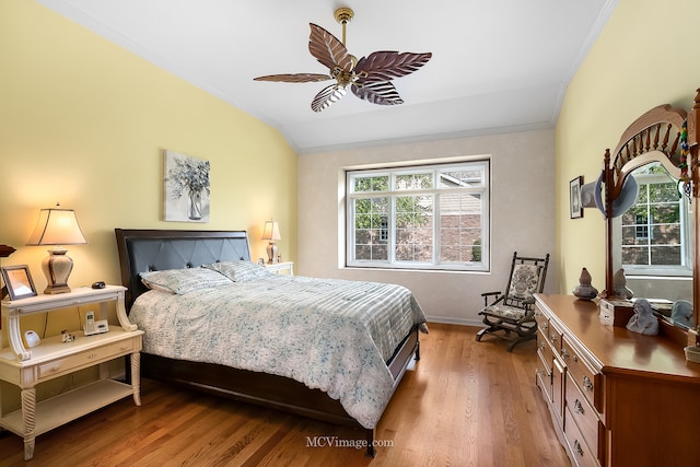 bedroom with ornamental molding, ceiling fan, and light hardwood / wood-style floors