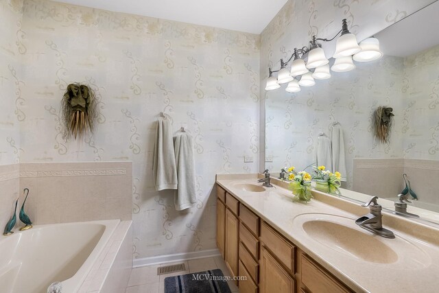 bathroom featuring a relaxing tiled tub, tile patterned floors, and dual bowl vanity