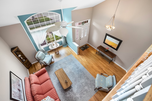 living room with ceiling fan, hardwood / wood-style floors, and high vaulted ceiling