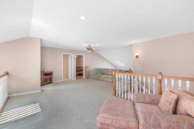 living room featuring vaulted ceiling, carpet, and ceiling fan