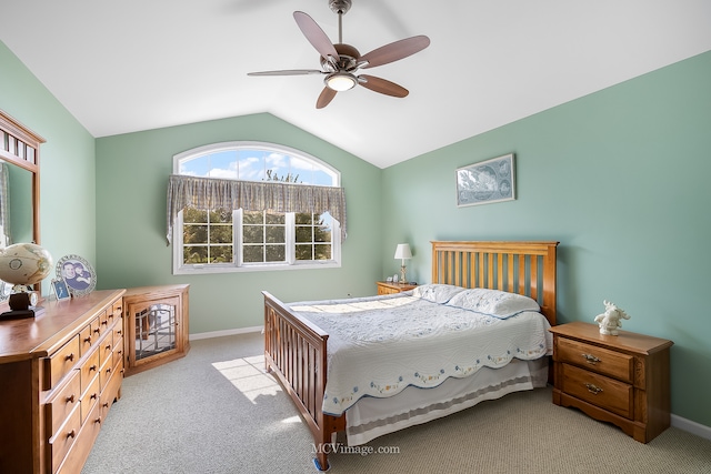 carpeted bedroom with ceiling fan and vaulted ceiling