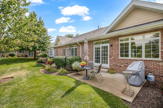 rear view of property featuring a patio and a lawn