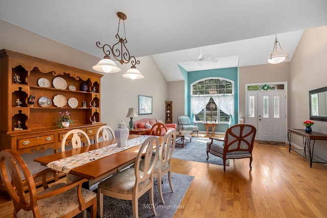 dining area with lofted ceiling, ceiling fan, and light wood-type flooring